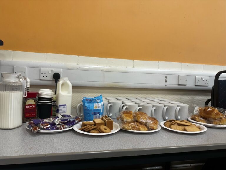 biscuits, milk and mugs laid out on a table ready for break time